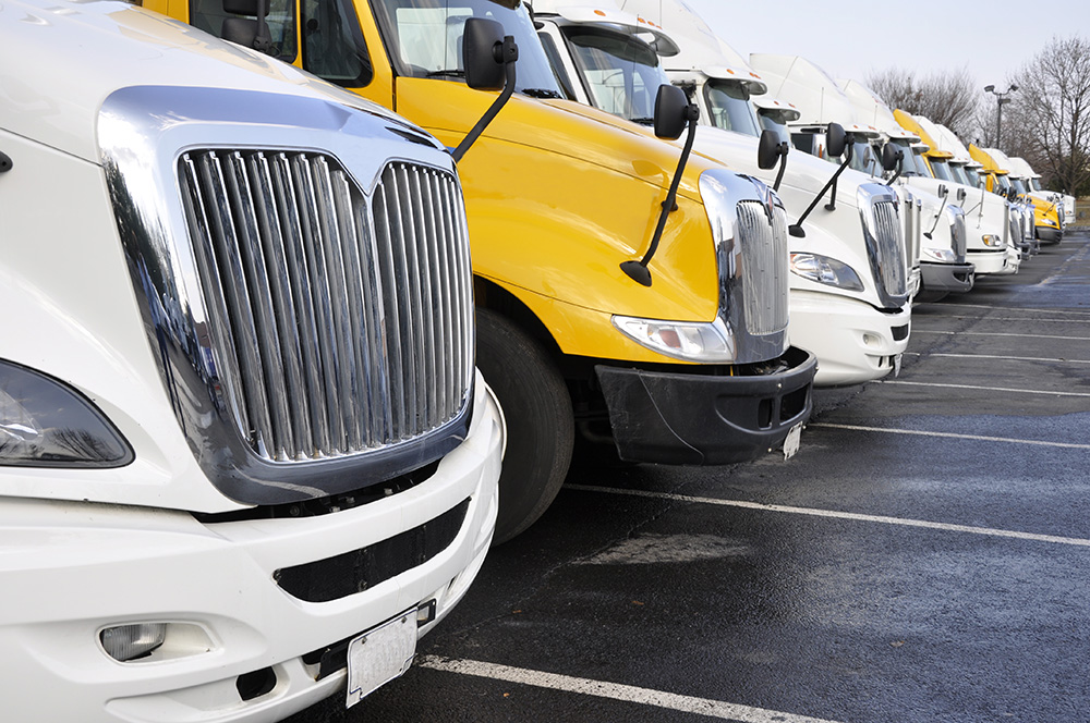 view of the front end of large trucks in a row